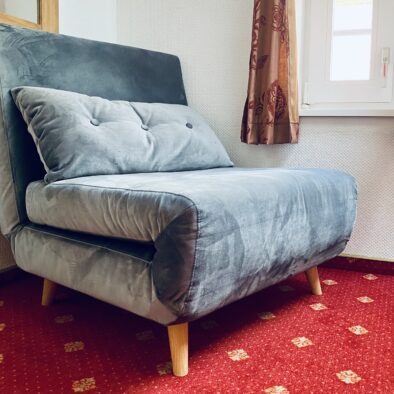 Schlafsessel im Schlafzimmer der Ferienwohnung Sperlings Lus auf dem Ferienhof Hofbude Fehmarn